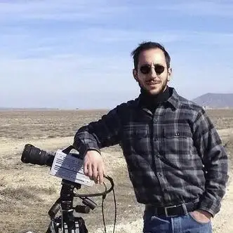 Nihat Şükrü Özgören standing outdoors beside biomechanics equipment